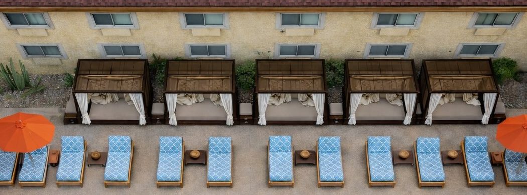 Private cabanas and orange umbrellas along the Hotel Embarque pool deck